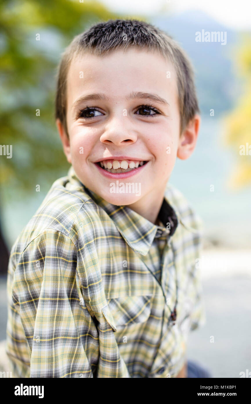 portrait of 9 year old boy smiling with colorful checkered shirt