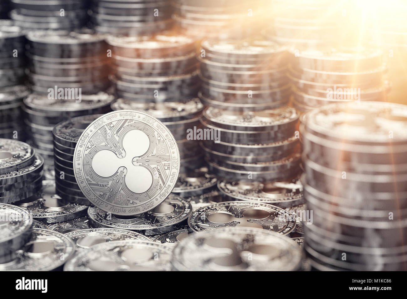 Silver Ripple coin among stack and piles of coins. Bright sun flare as ...