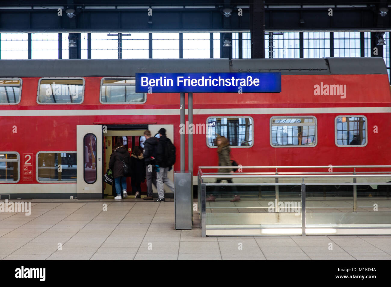 Passengers boarding a train at the Berlin Friedrichstrasse rail station in the German capital Berlin Stock Photo