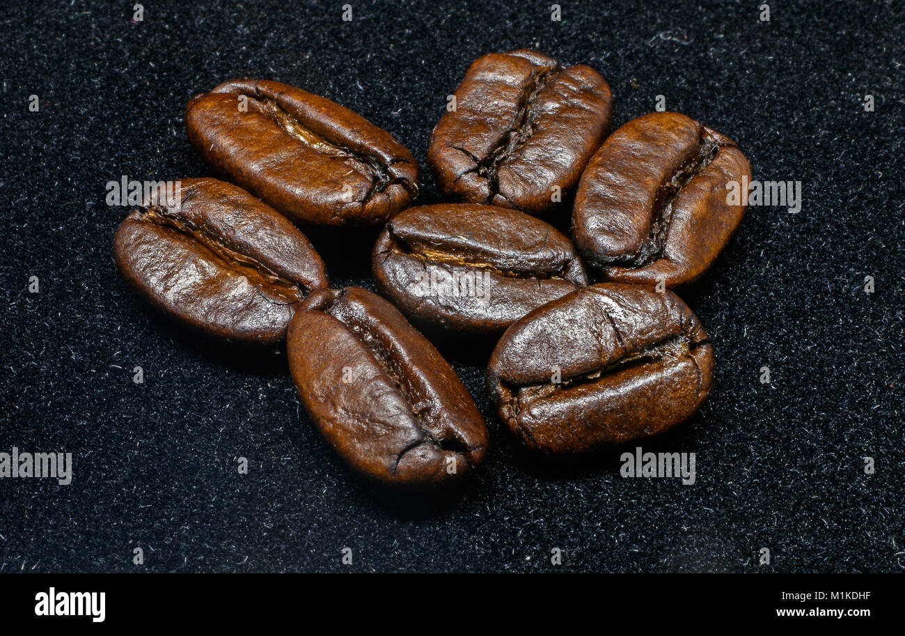Roasted coffee beans on black background Stock Photo - Alamy