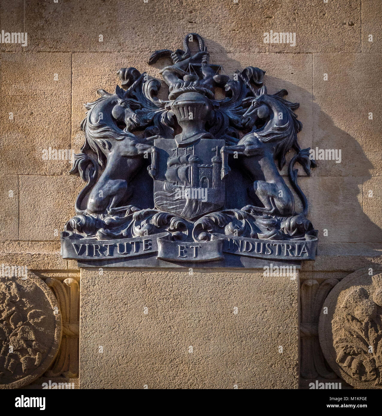 Bristol City coat of arms in bronze on the war memorial in the city centre with the motto Virtute et Industria or by Virtue and Industry - Bristol UK Stock Photo