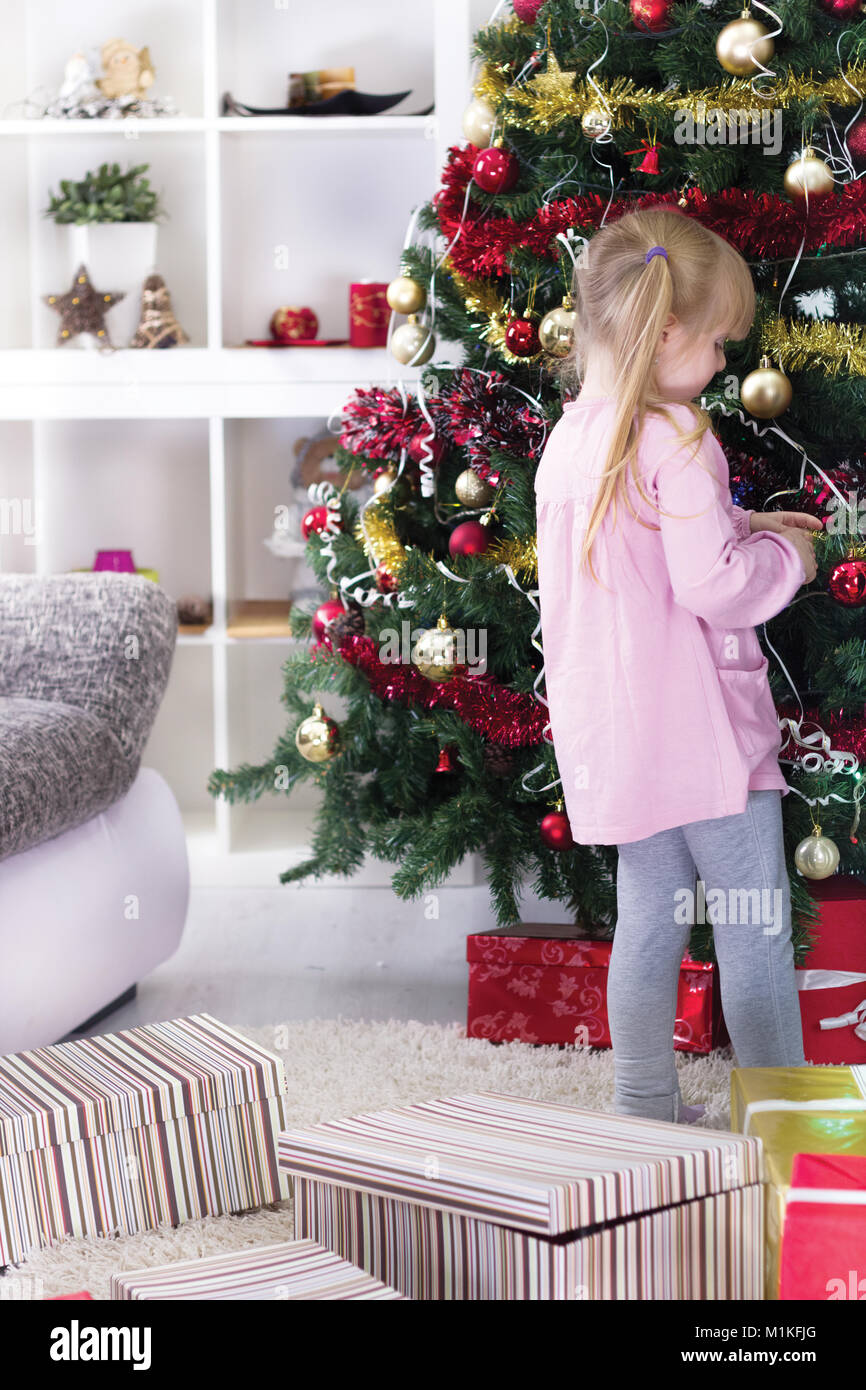 a young little girl decorating the Christmas tree Stock Photo - Alamy