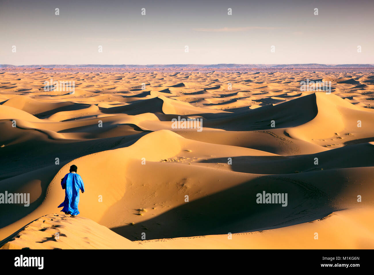 Morocco, Mhamid, Erg Chigaga sand dunes. Sahara desert. Local Berber man, nomad on sand dune. Stock Photo