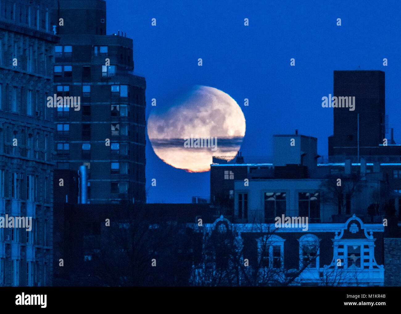 New York, USA, 31 Jan 2018.  The start of a lunar eclipse is seen over New York City early on January 31, 2018. A rare coincidence of a blue moon, supermoon and total lunar eclipse will cause a 'blood' moon - an event that hasn't happened in more than 150 years. Photo by Enrique Shore/Alamy Live News Stock Photo