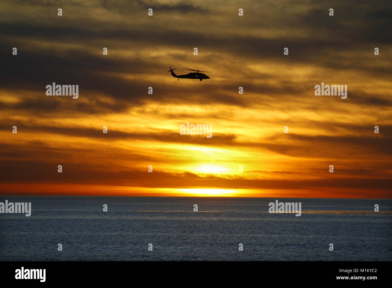 San Diego, CA, USA. 29th Jan, 2018. January 29, 2018- San Diego, California, USA- A Navy Sikorsky SH-60 Seahawk flies during sunset off the coast of San Diego, CA, on Jan. 31, 2018. Credit: KC Alfred/ZUMA Wire/Alamy Live News Stock Photo