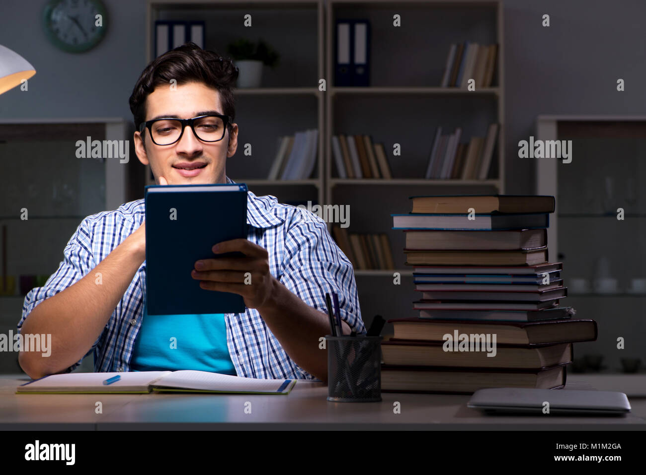 Student preparing for exams late night at home Stock Photo - Alamy