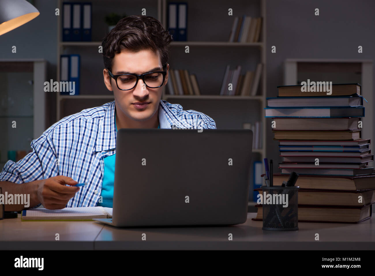 Student preparing for exams late night at home Stock Photo - Alamy