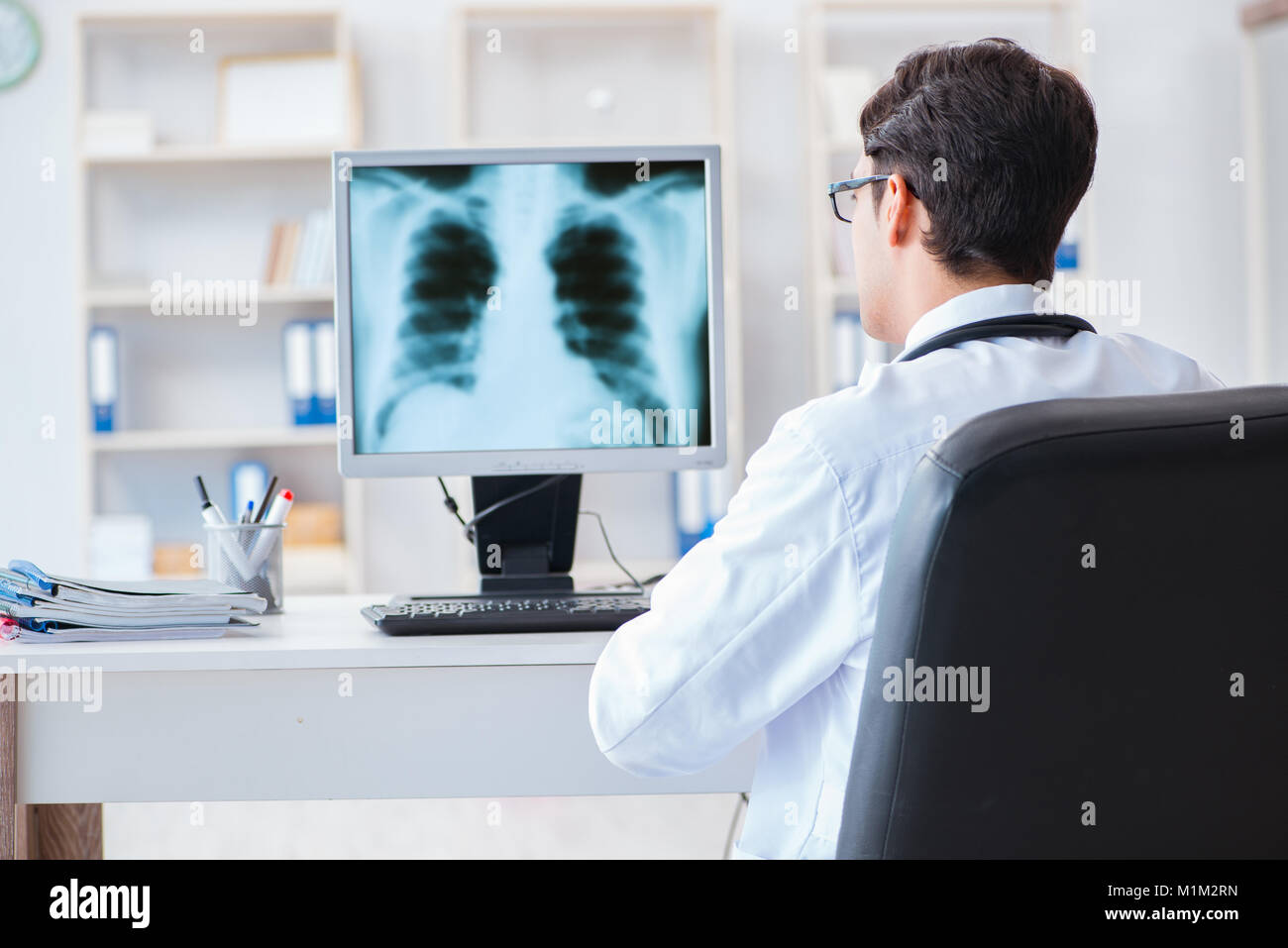 Doctor radiologist looking at xray images Stock Photo Alamy