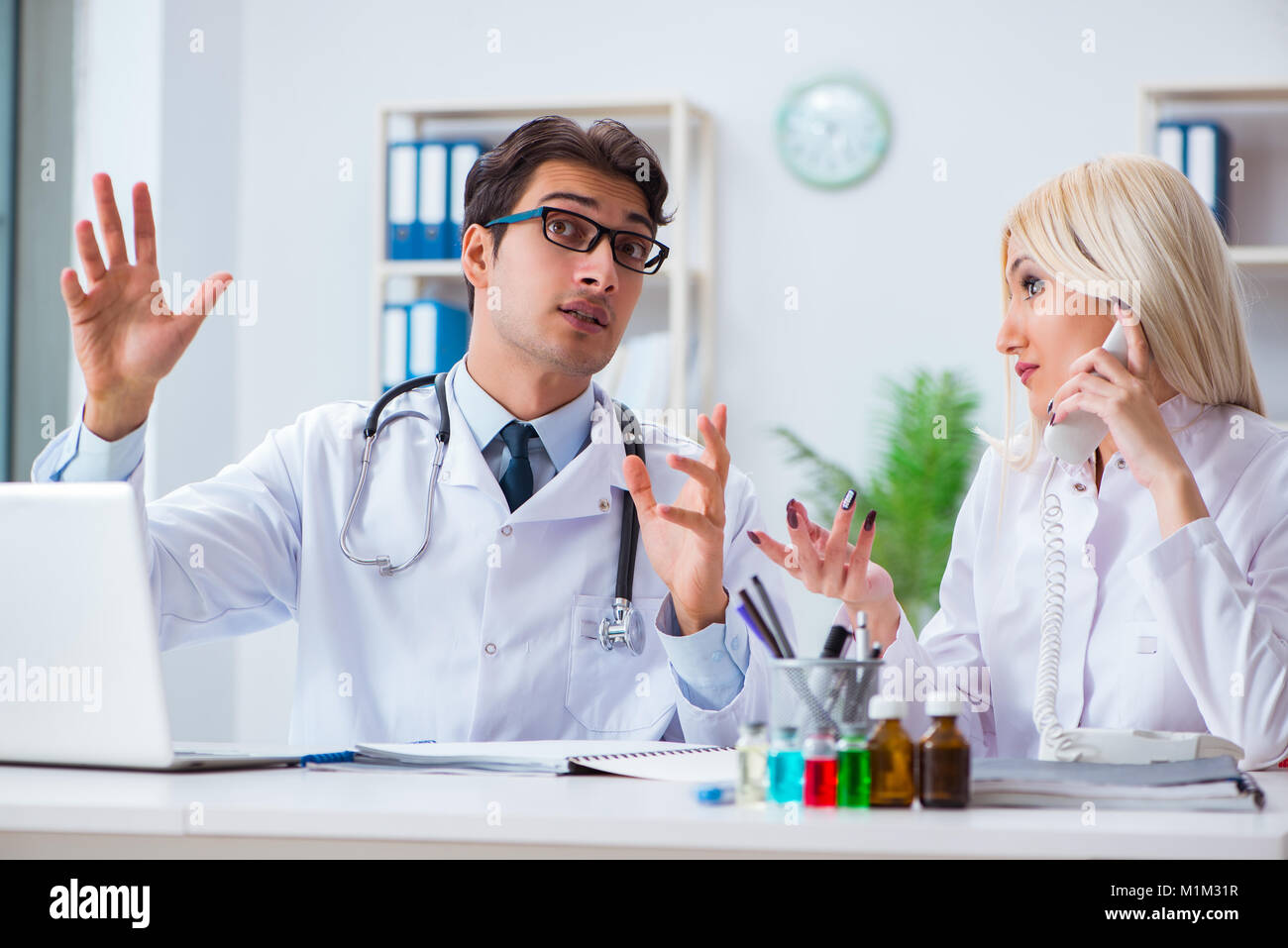 Male and female doctor having discussion in hospital Stock Photo - Alamy