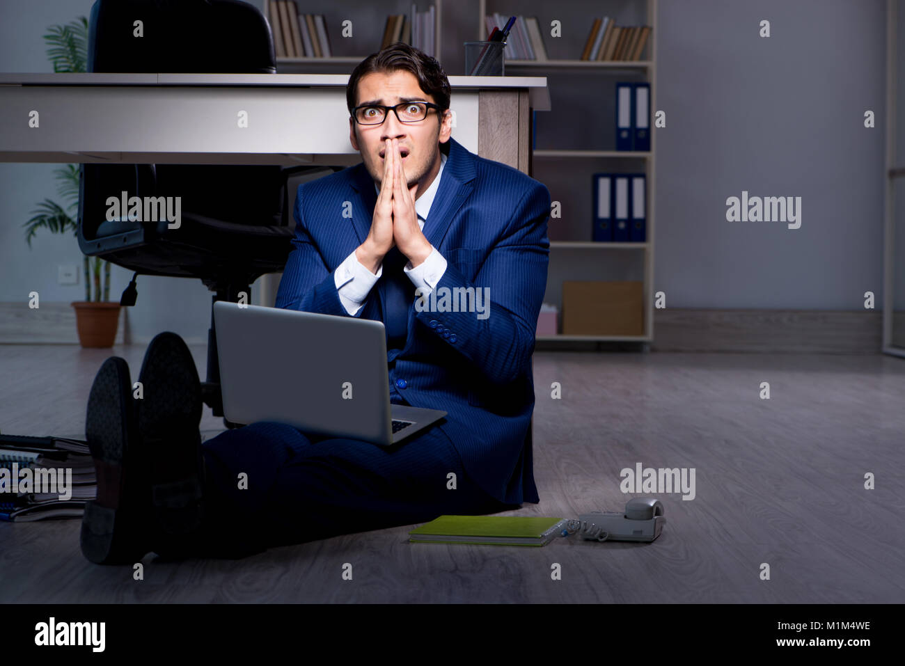 Businessman working overtime long hours late in office Stock Photo - Alamy