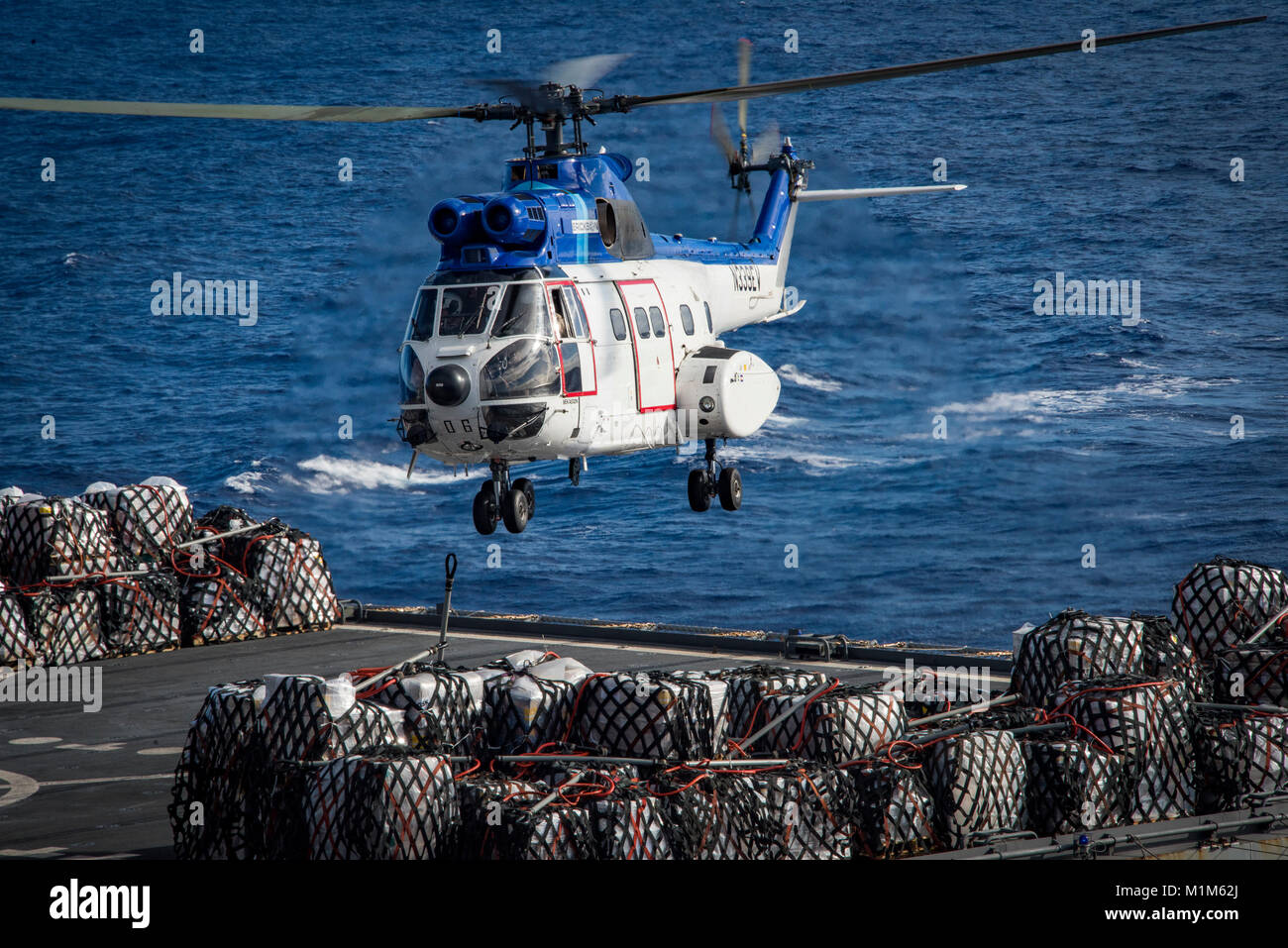 180126-N-CG677-0065  PACIFIC OCEAN (Jan. 26, 2018) An SA-330 Puma helicopter assigned to the dry cargo and ammunition ship USNS Wally Schirra (T-AKE 8) participates in a replenishment-at-sea with the Nimitz-class aircraft carrier USS Carl Vinson (CVN 70). The Carl Vinson Carrier Strike Group is operating in the Pacific Ocean as part of a regularly scheduled deployment. (U.S. Navy photo by Mass Communication Specialist 3rd Class Jake Cannady/Released) Stock Photo