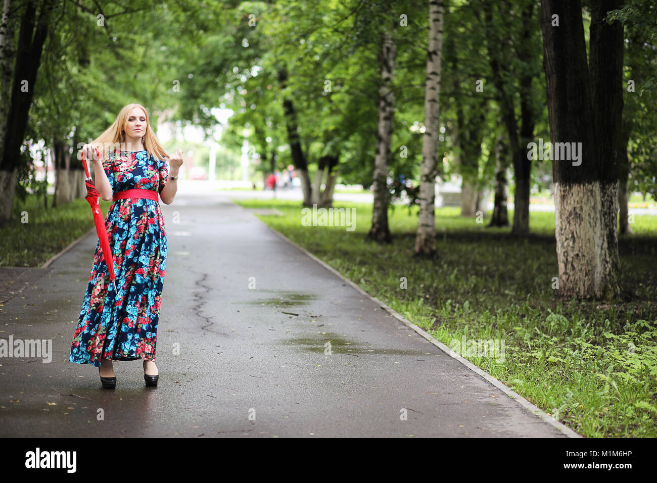Girl in the street with an umbrella Stock Photo - Alamy