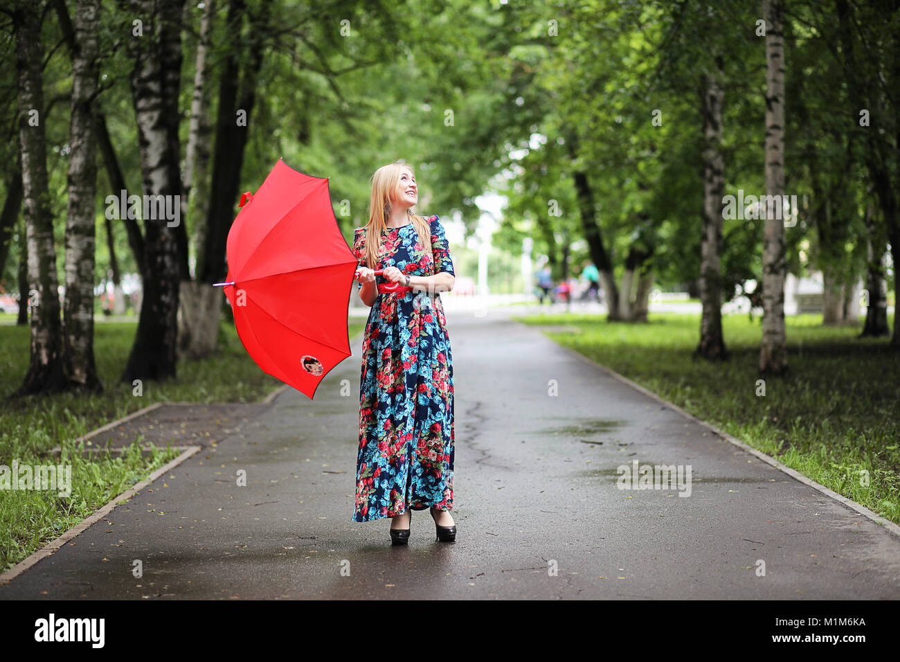 Girl in the street with an umbrella Stock Photo - Alamy