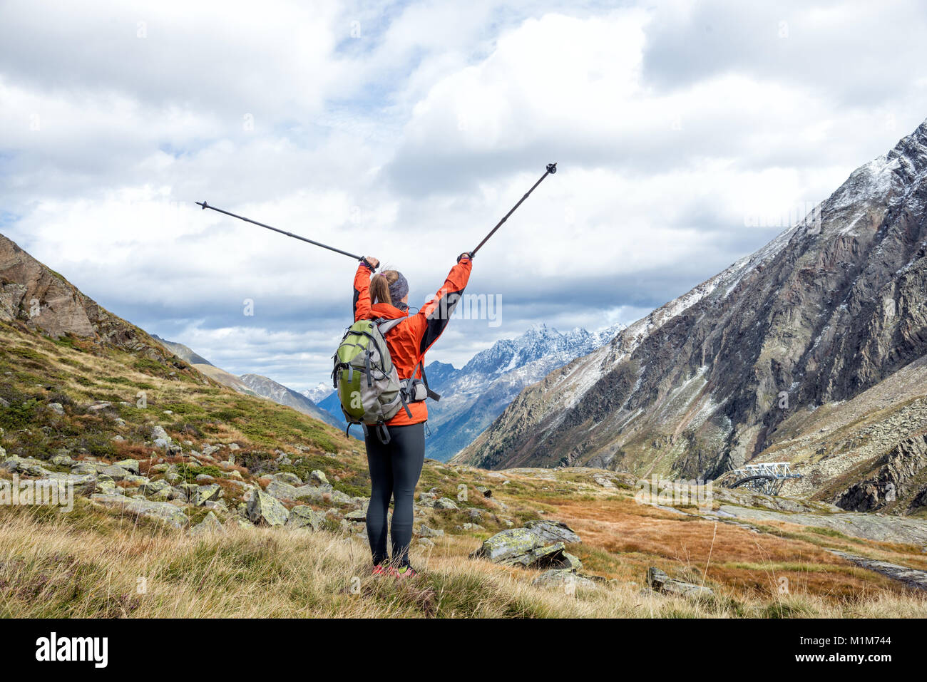 Young woman with backpack hiking in the mountains. Alps Stock Photo - Alamy