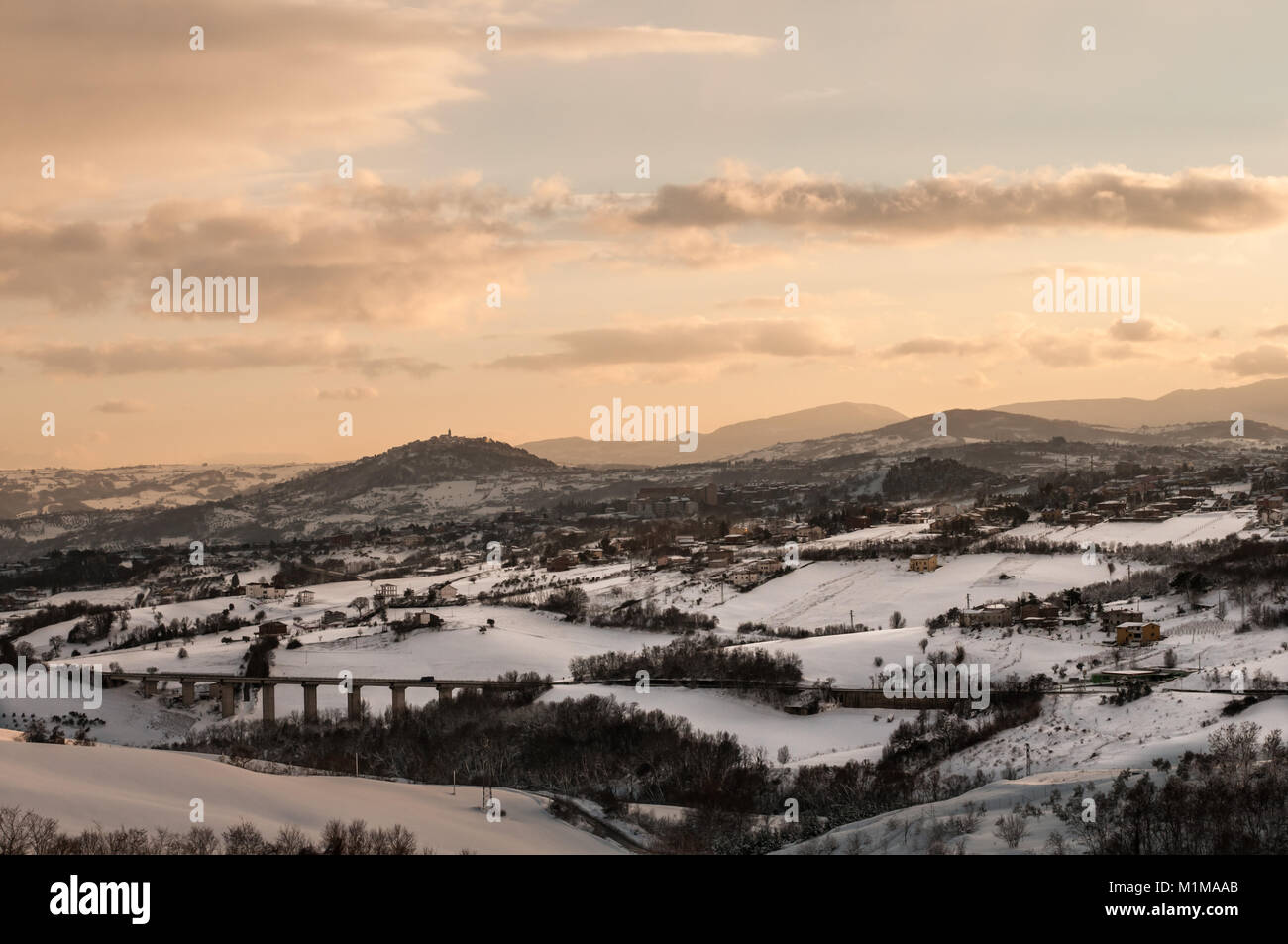 Ferrazzano and campobasso view from countryside after a snowfall in winter at the sunset . Stock Photo