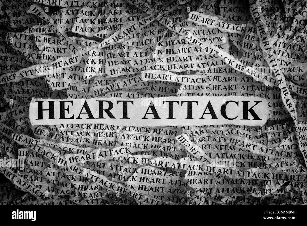 Heart Attack. Torn pieces of paper with the word Heart Attack. Concept Image. Black and White. Closeup. Stock Photo