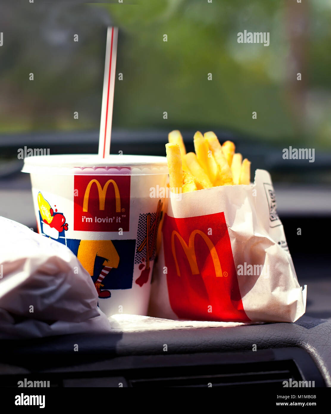 SOFIA, BULGARIA - JUNE 01, 2015: McDonalds Meal on a front of a car, Mcdrive fast food service conceptual background Stock Photo