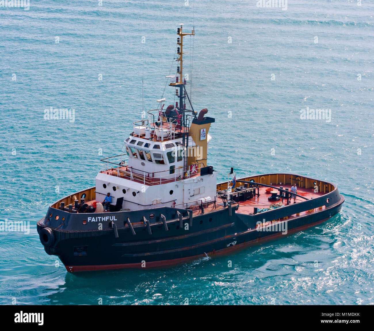A tugboat named 'Faithful' in the ocean just off of Bermuda coast Stock Photo