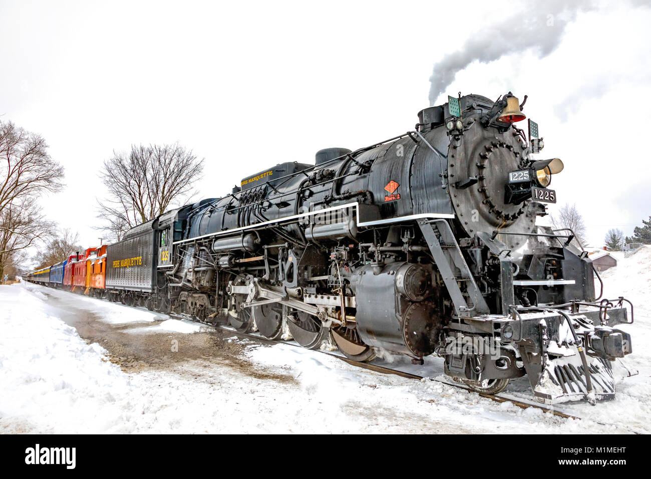 The Pere Marquette 1225 “North Pole Express” a vintage steam engine, spewing steam on a snowy day Stock Photo