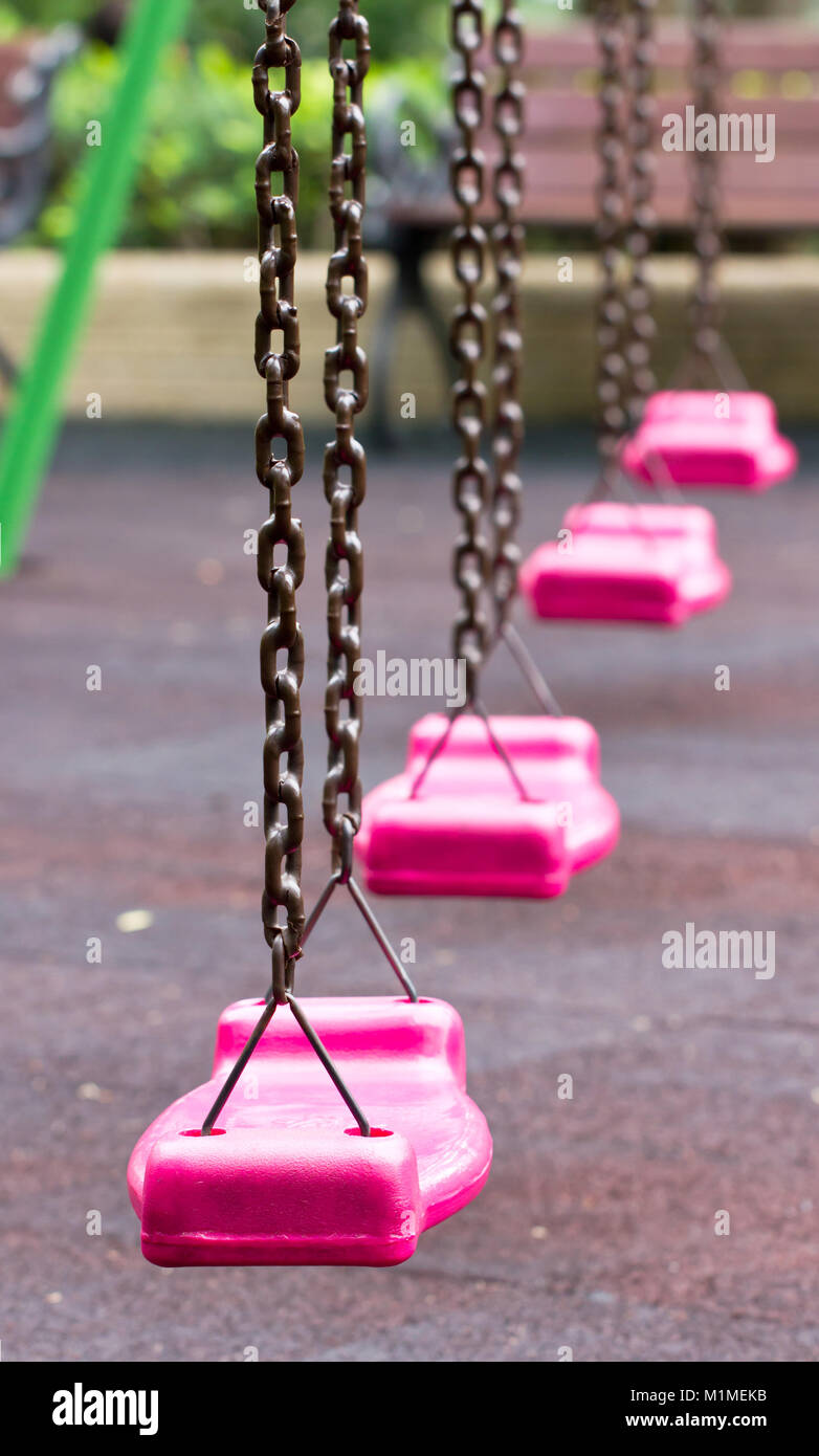 Close up of pink swing in playground. Stock Photo
