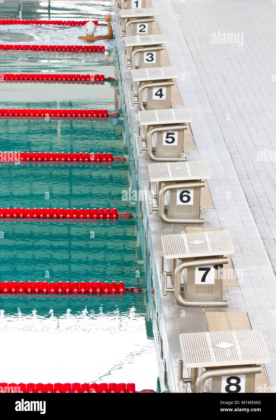 Empty swimming pool with starting block. Stock Photo