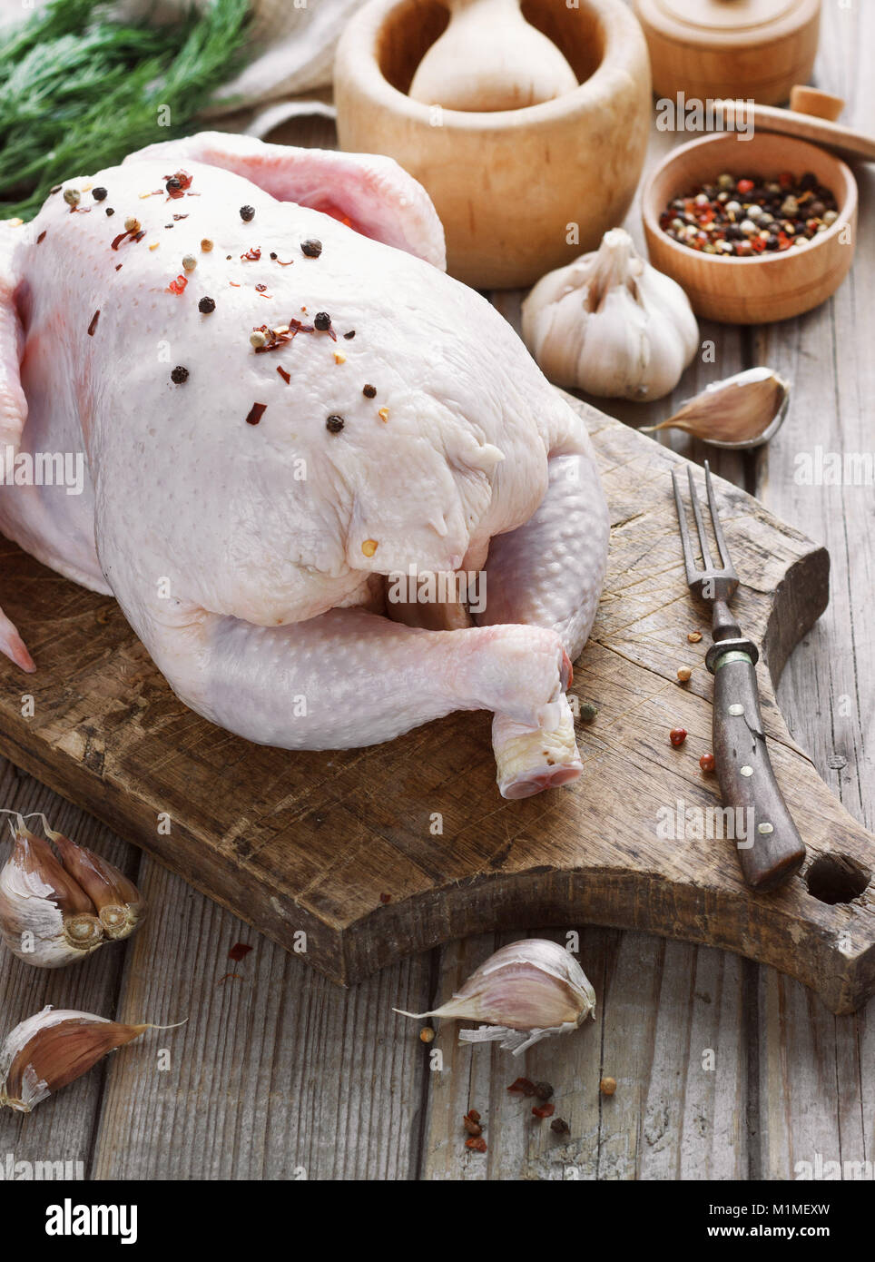 chicken carcass on a wooden background with spices, cooking in the