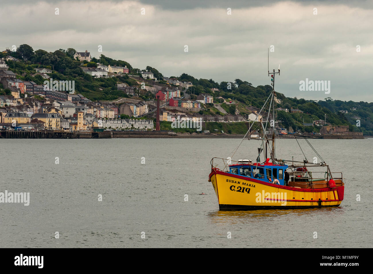 Small trawler fishes off Cobh, County Cork, Ireland with copy space. Stock Photo