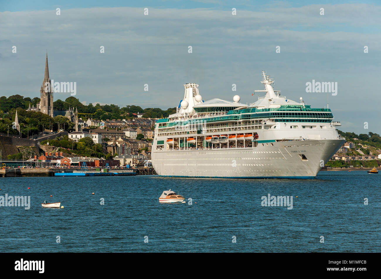 Cruise Liner 'Vision of the Seas' swings in Cobh, Ireland as she sets sail for her next port of call on a summers day with copy space. Stock Photo
