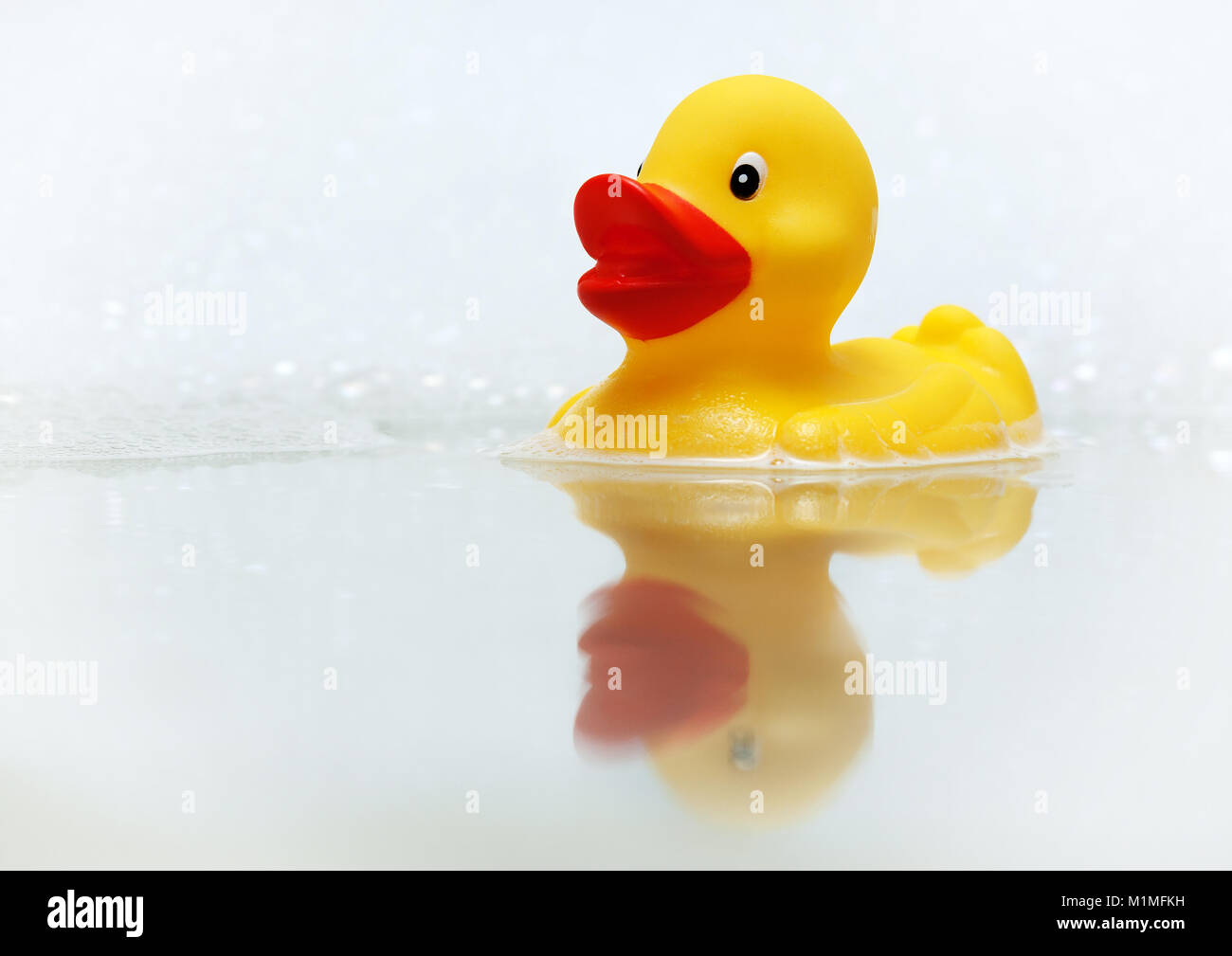 Yellow rubber duck in bath with bubbles Stock Photo - Alamy