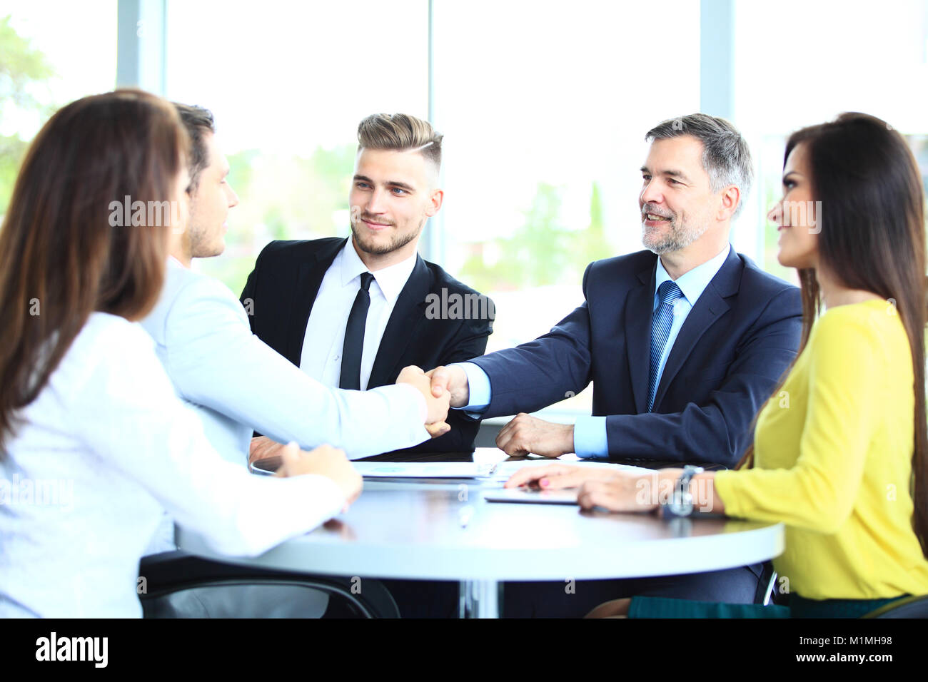 Business people shaking hands, finishing up a meeting Stock Photo - Alamy