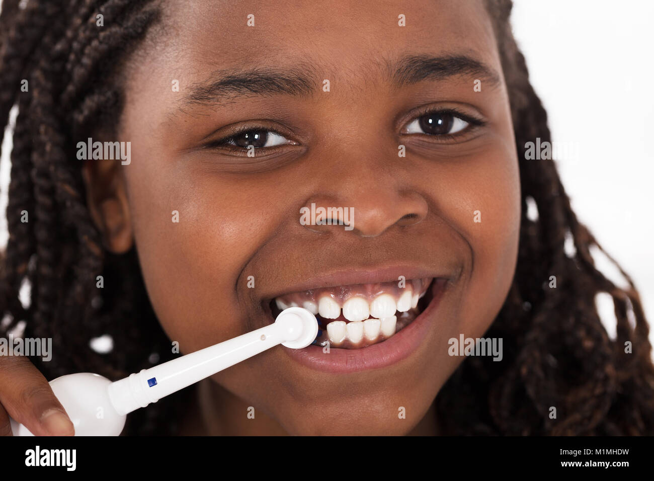 Portrait Of An African Girl Brushing Her Teeth Stock Photo