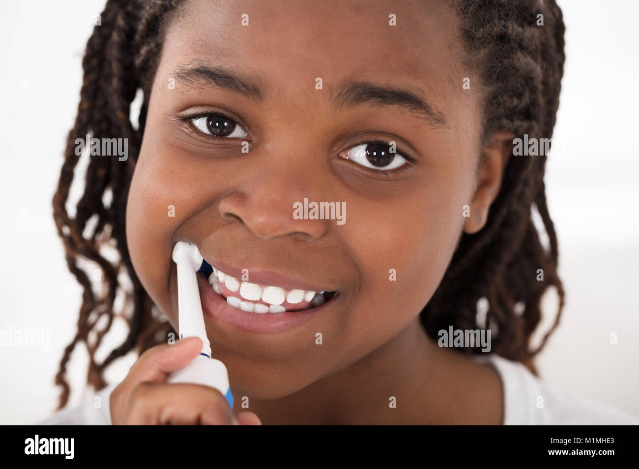 Portrait Of An African Girl Brushing Her Teeth Stock Photo