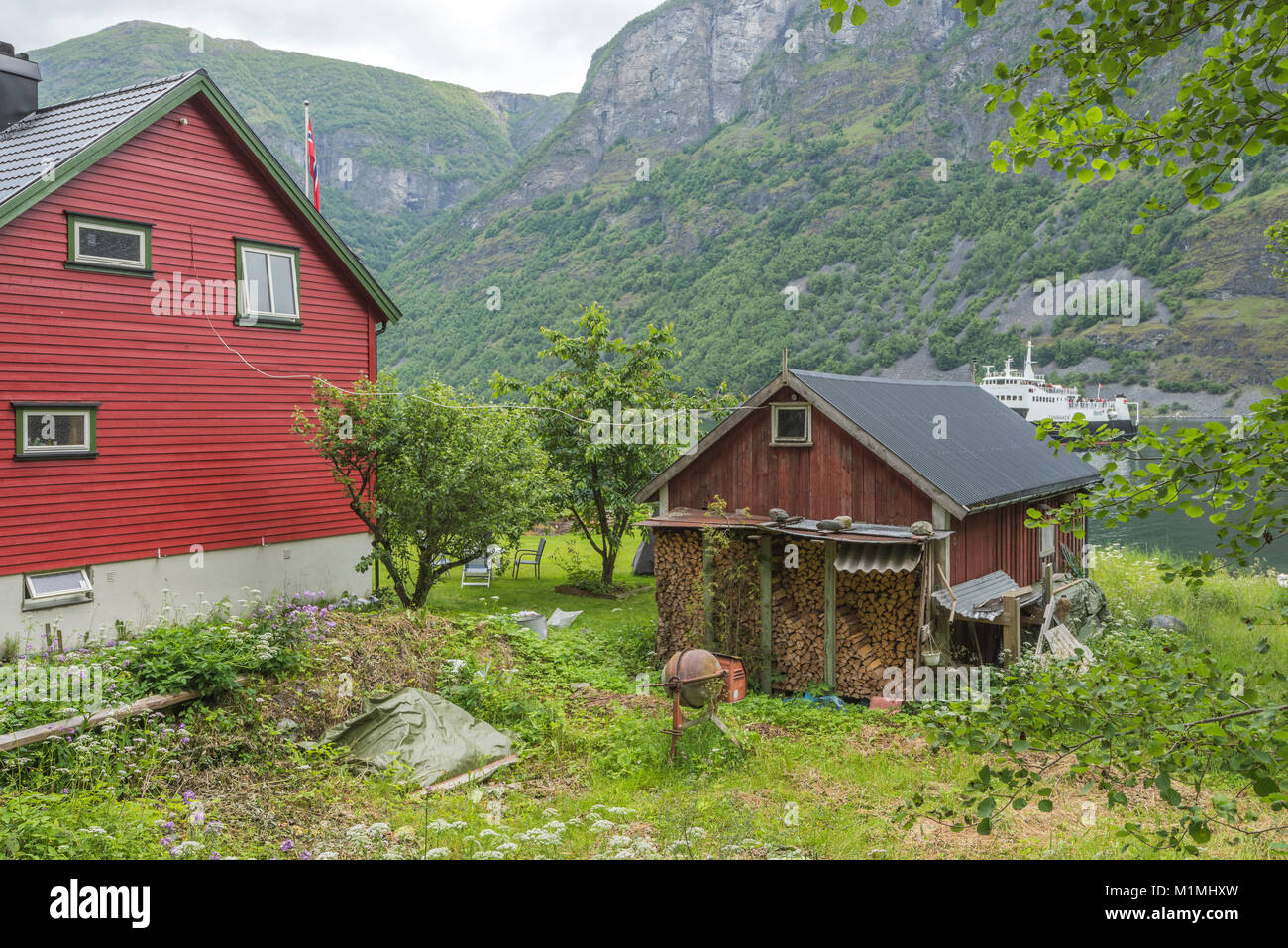 house and rural idyll at the seashore of Undredal, small village on the fjord Aurlandsfjorden, Norway, Scandinavia, ferry of the Sognefjorden Stock Photo