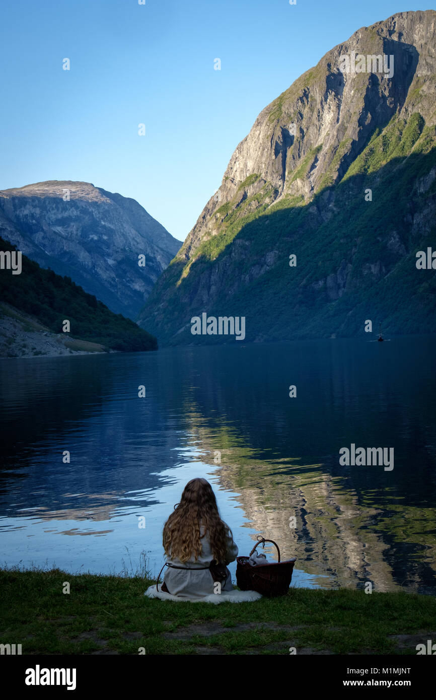 Girl sitting by a fjord,Gudvangen,Aurland,Sogn og Fjordane,Norway Stock Photo