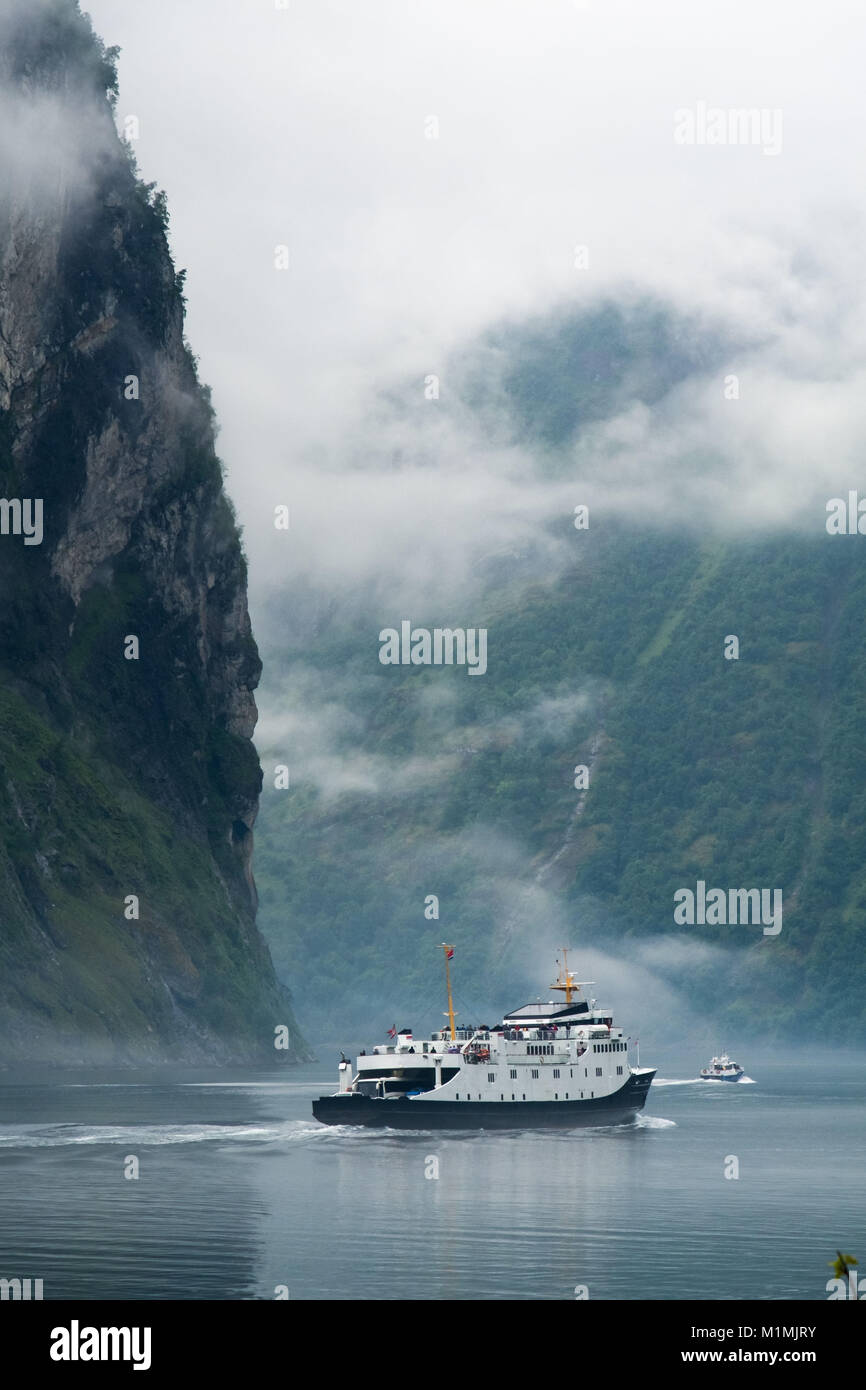 Boats sailing on Geiranger fjord in the mist, More og Romsdal, Norway Stock Photo