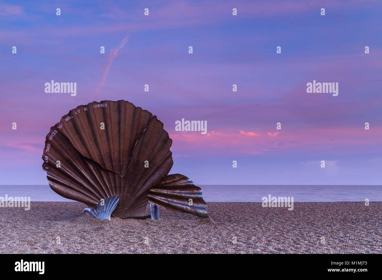 Scallop Shell Sculpture at Sunset with beautiful pink sky on Aldeburgh Beach in Suffolk, England Stock Photo