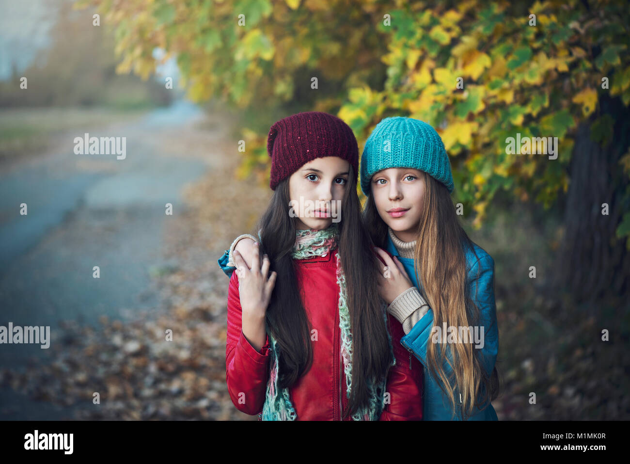 Portrait of two girls with their arms around each other Stock Photo