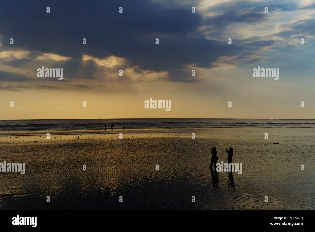 Silhouette of two people on beach, Gili Trawangan, Lombok Utara, West Nusa Tenggara, Indonesia Stock Photo