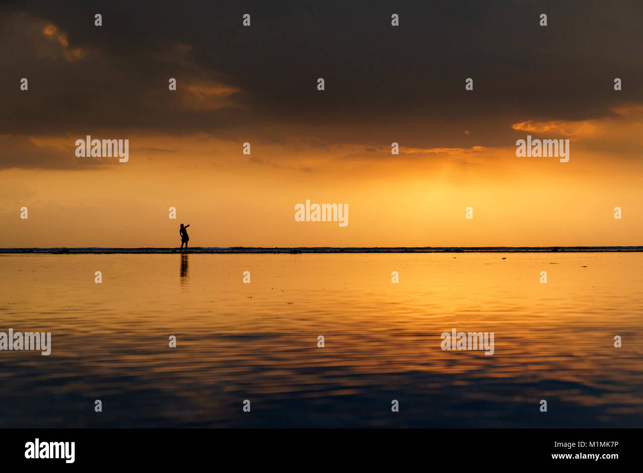 Silhouette of one person standing on beach, Gili Trawangan, Lombok Utara, West Nusa Tenggara, Indonesia Stock Photo