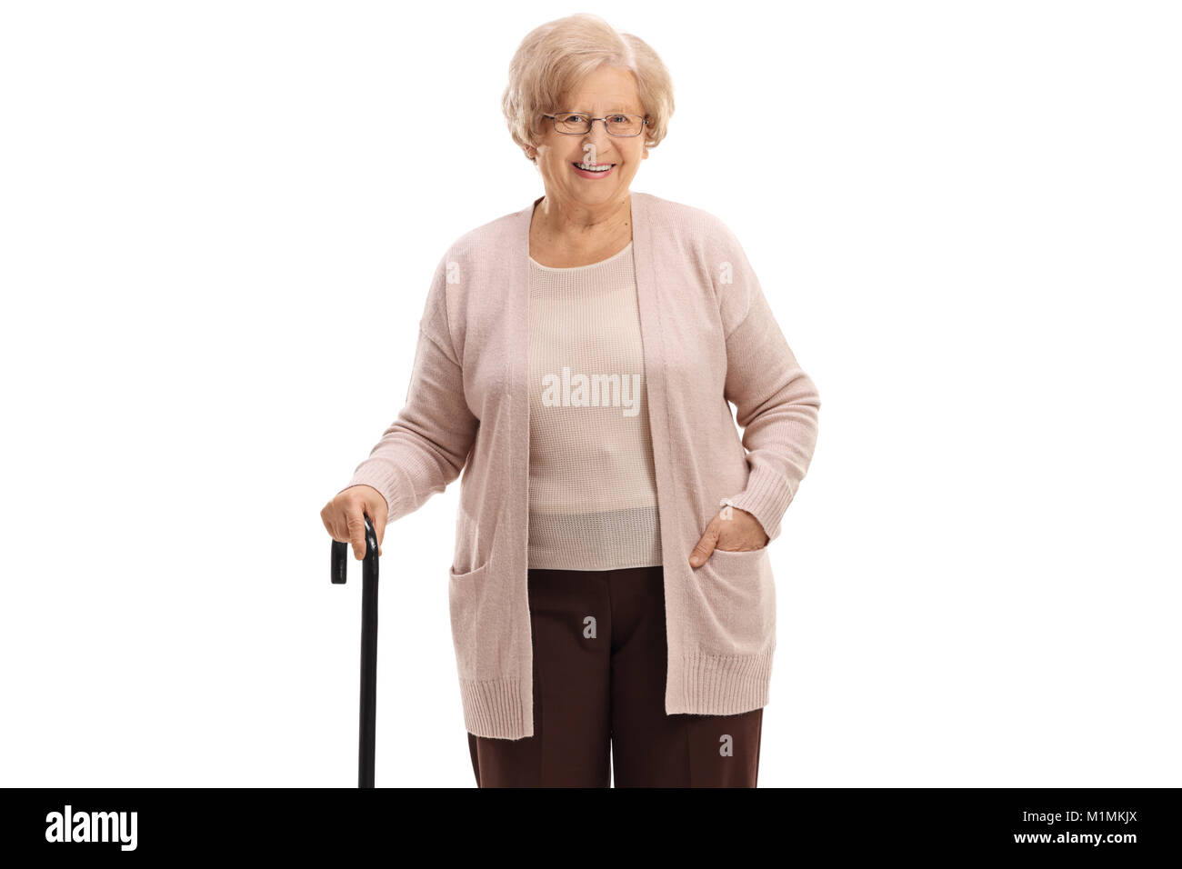 Elderly woman with a walking cane looking at the camera and smiling isolated on white background Stock Photo