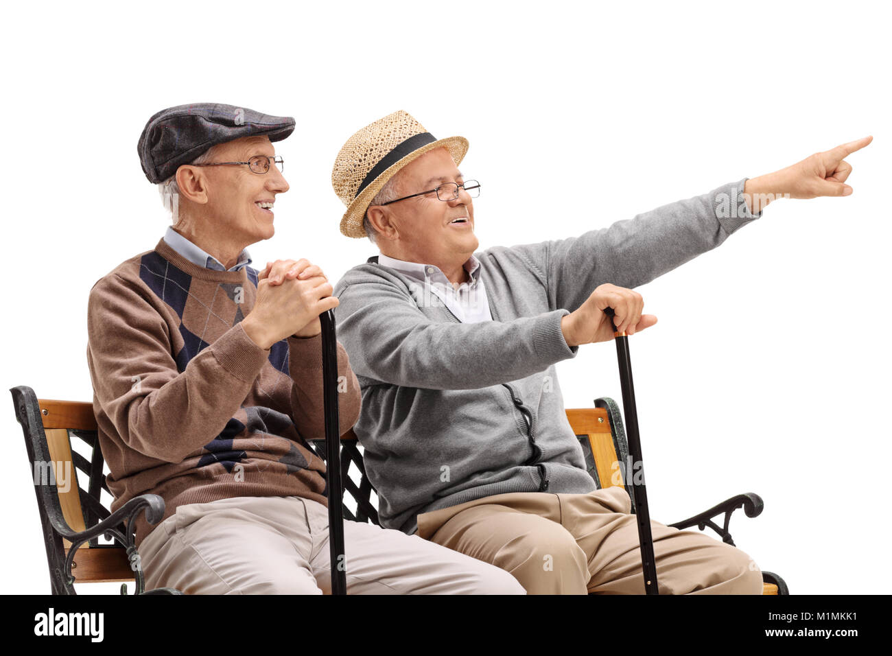 Senior seated on a bench showing something to another senior isolated on white background Stock Photo