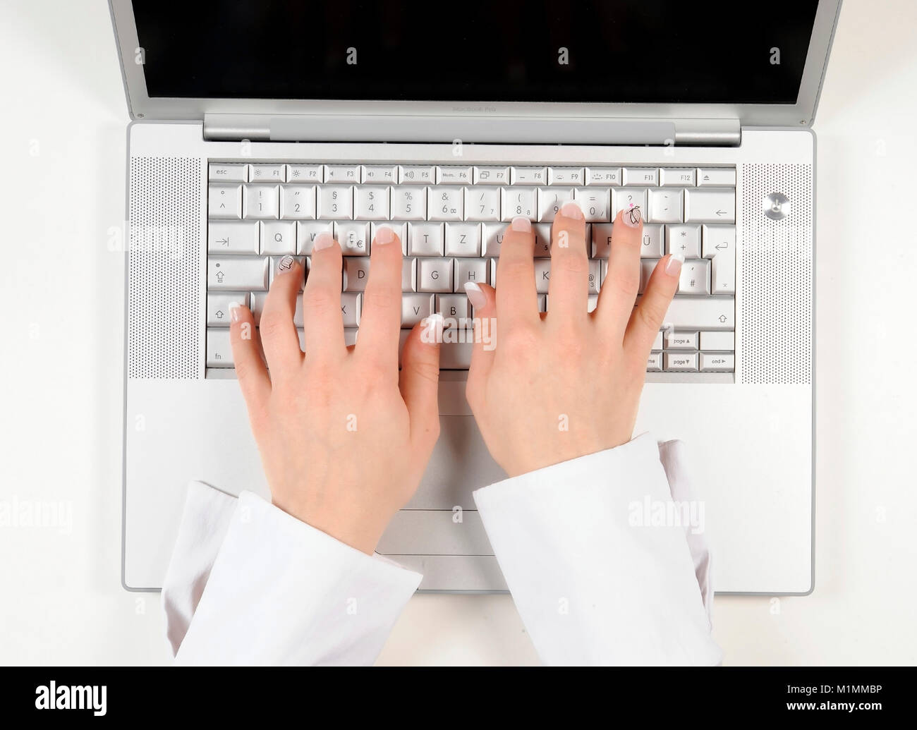 Two women hands writing on computer to Apple MacBook Pro keyboard, Zwei Frauenhaende schreiben auf Tastatur Computer Apple MacBook Pro Stock Photo