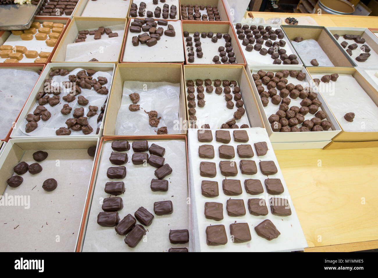 Assorted chocolate candy in boxes in back of a candy store Stock Photo