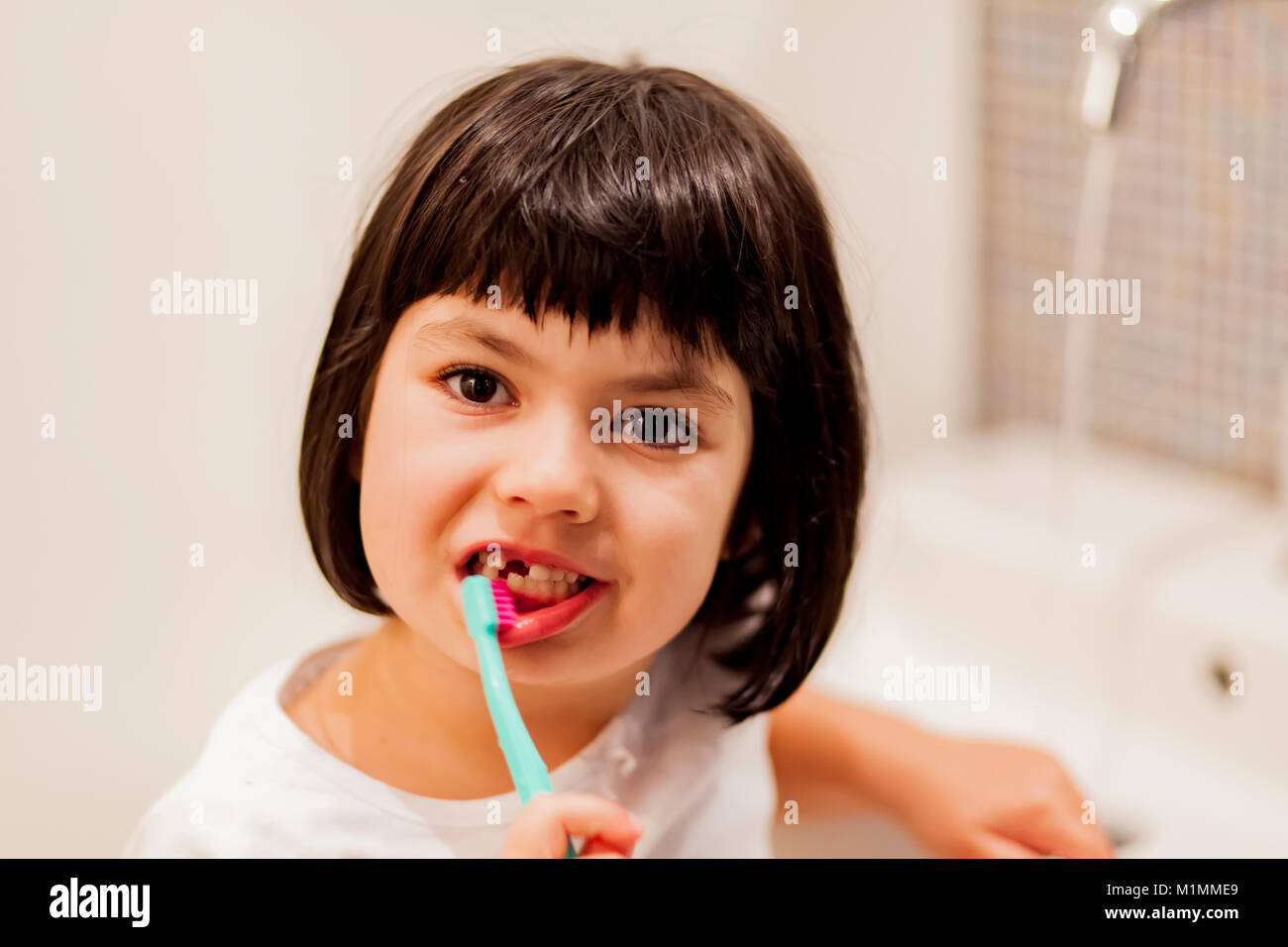 Portrait of little girl brushing teeth Stock Photo