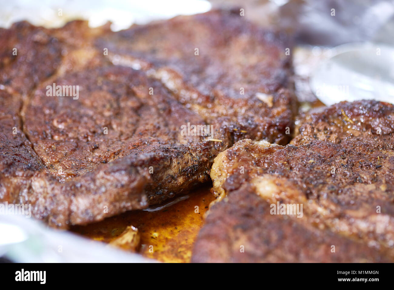 Ribeye beef steak on tin foil, resting after cooking Stock Photo Alamy