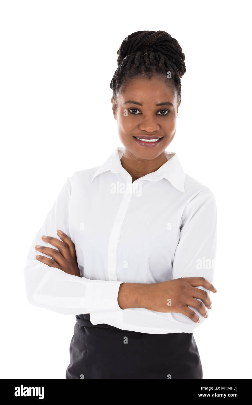 Portrait Of Happy African Hostess Standing Arms Crossed Against White Background Stock Photo