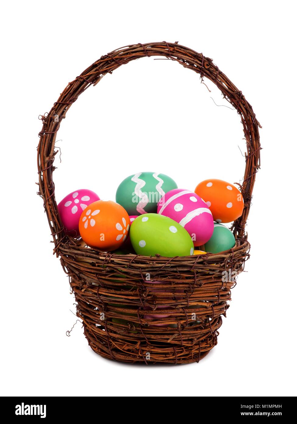 Easter basket filled with colorful hand painted Easter Eggs over a white background Stock Photo