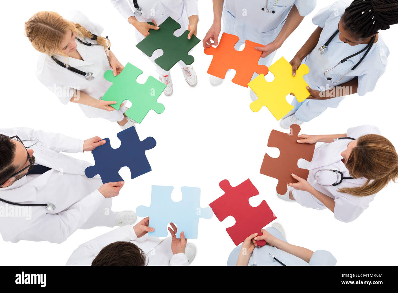 High Angle View Of Medical Team Solving Jigsaw Puzzle Stock Photo Alamy