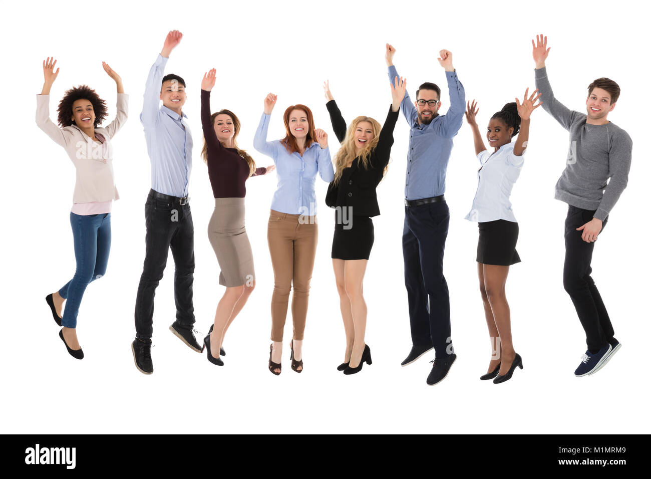 Portrait Of Excited College Students Raising Their Arms Over White Background Stock Photo