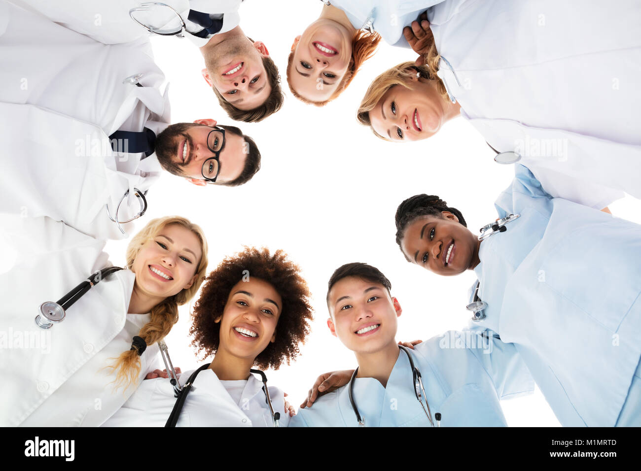 Low Angle View Of Happy Medical Team Forming Huddle Stock Photo - Alamy